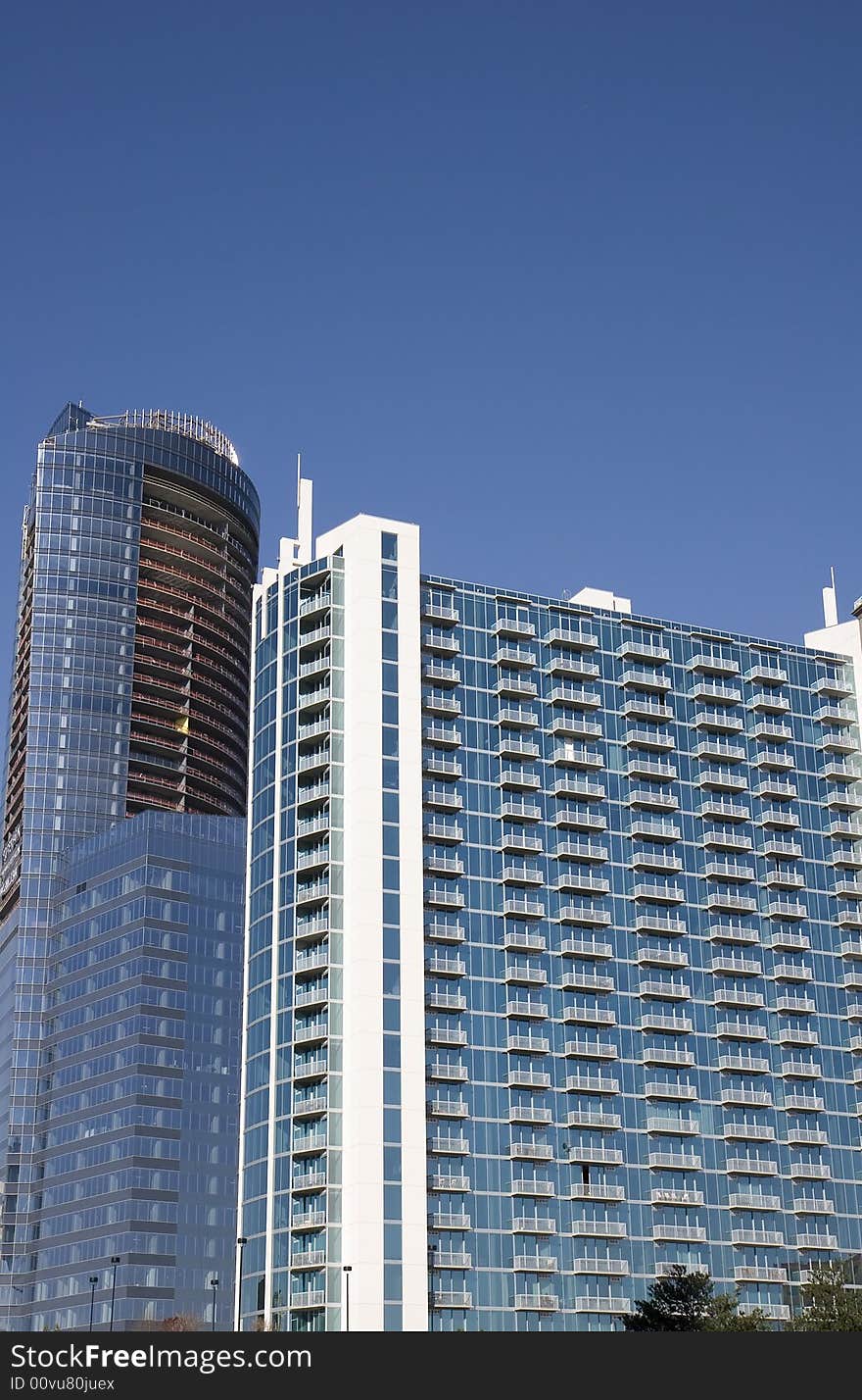 A modern high rise apartment building and a new tower under construction. A modern high rise apartment building and a new tower under construction