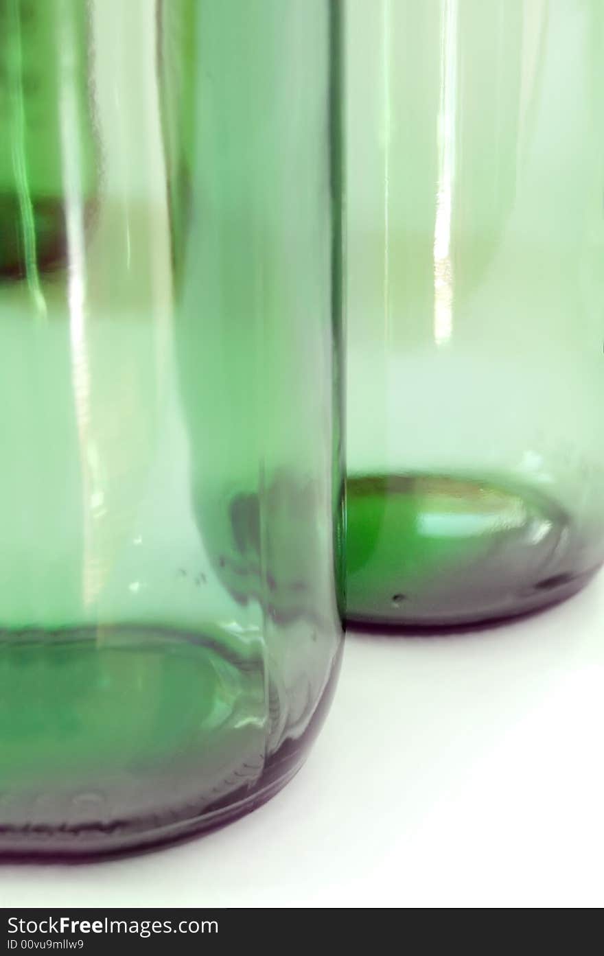 Two green glass bottles on white background. Two green glass bottles on white background