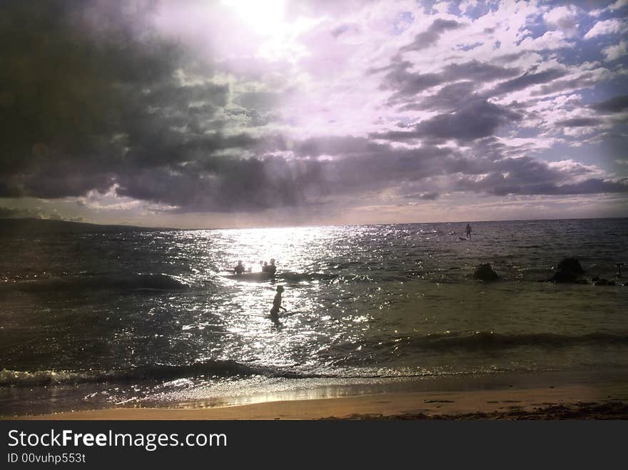 People in the ocean meeting sunset. People in the ocean meeting sunset