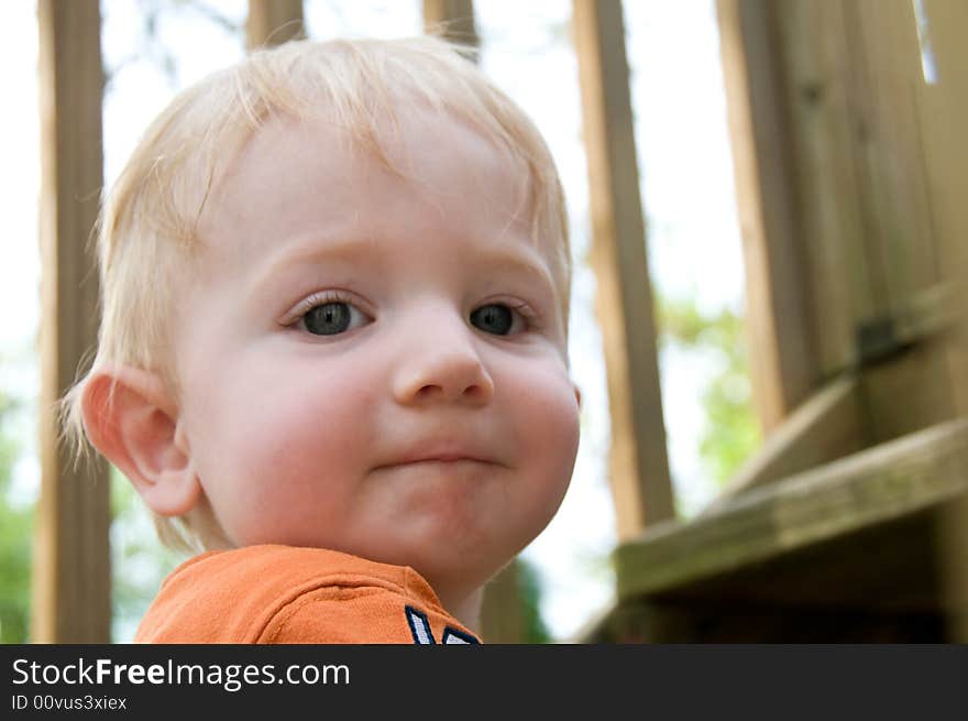 Cute little boy confidently climbs the stairs of a deck. Cute little boy confidently climbs the stairs of a deck