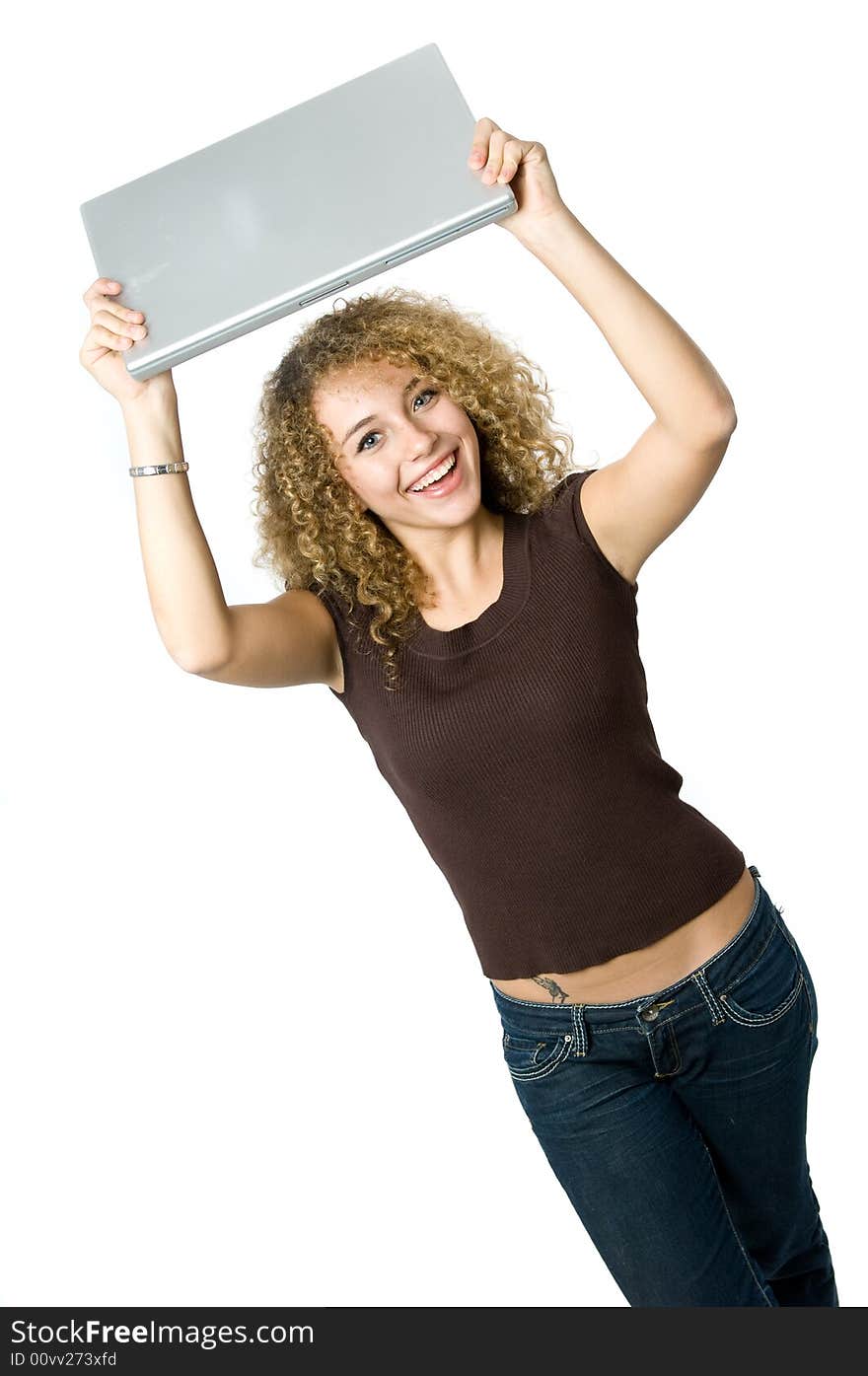 A beautiful young women holding her portable computer above her head. A beautiful young women holding her portable computer above her head