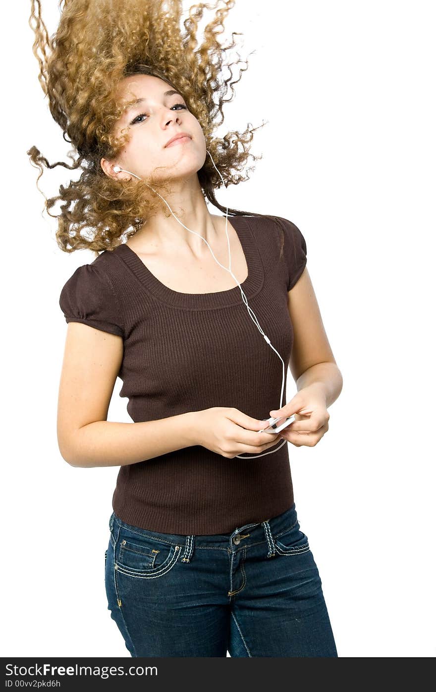 A beautiful young girl flicking her hair back to the music. A beautiful young girl flicking her hair back to the music