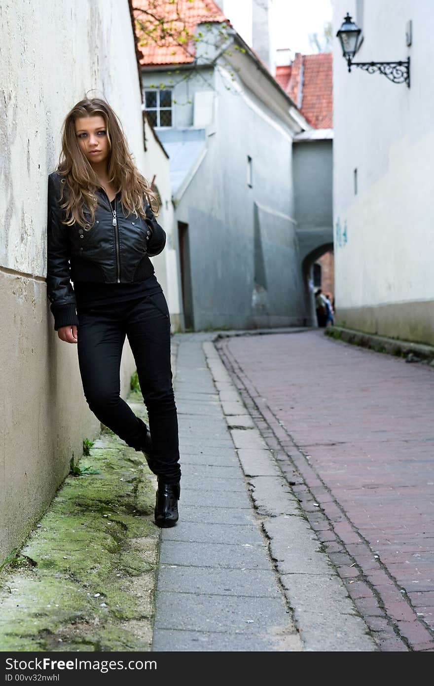 Portrait of the girl near wall