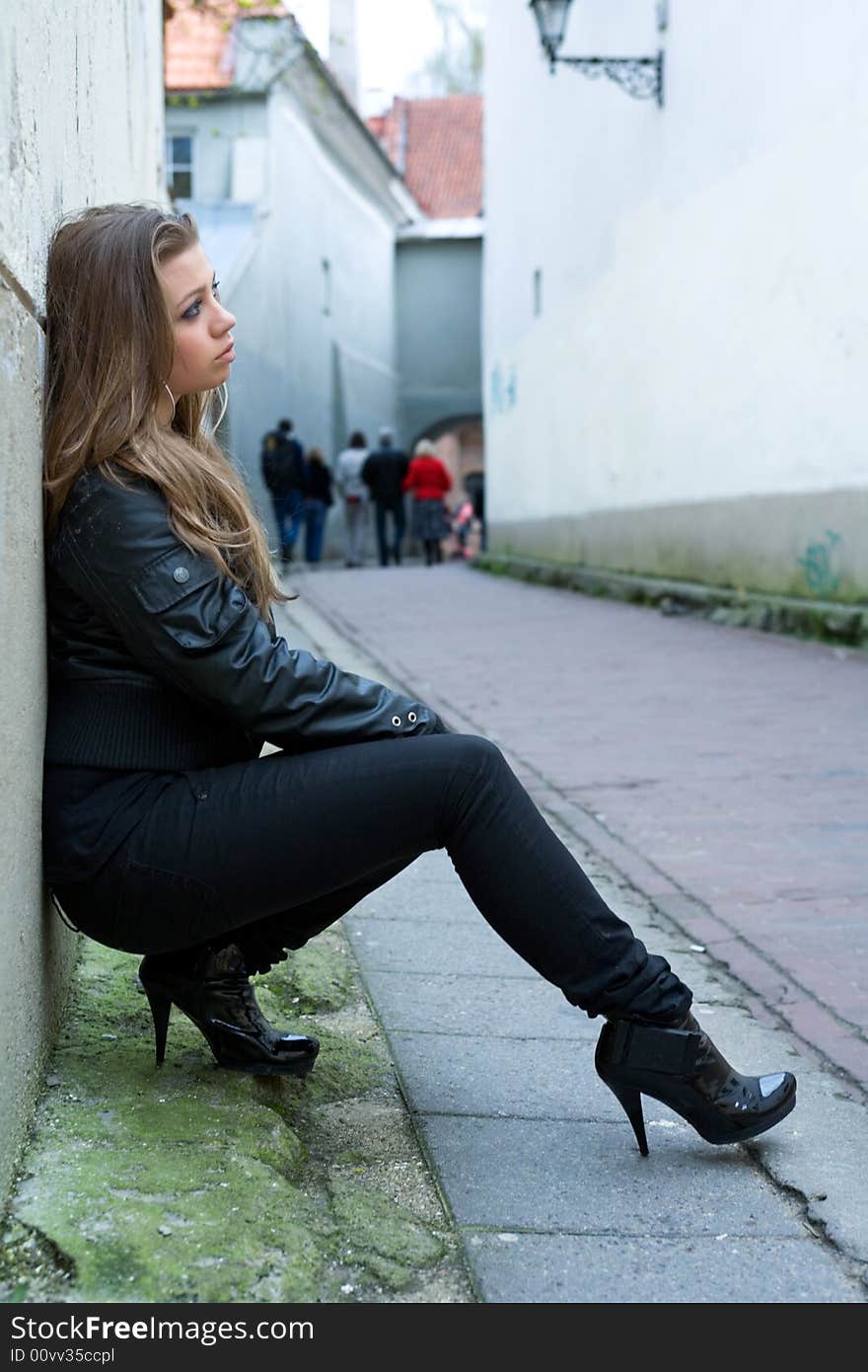 Portrait of the girl near wall