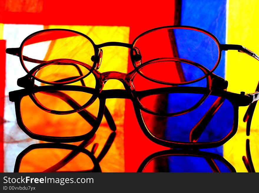 Abstract background design made from a stack of eyeglasses and numerous colors. Abstract background design made from a stack of eyeglasses and numerous colors.