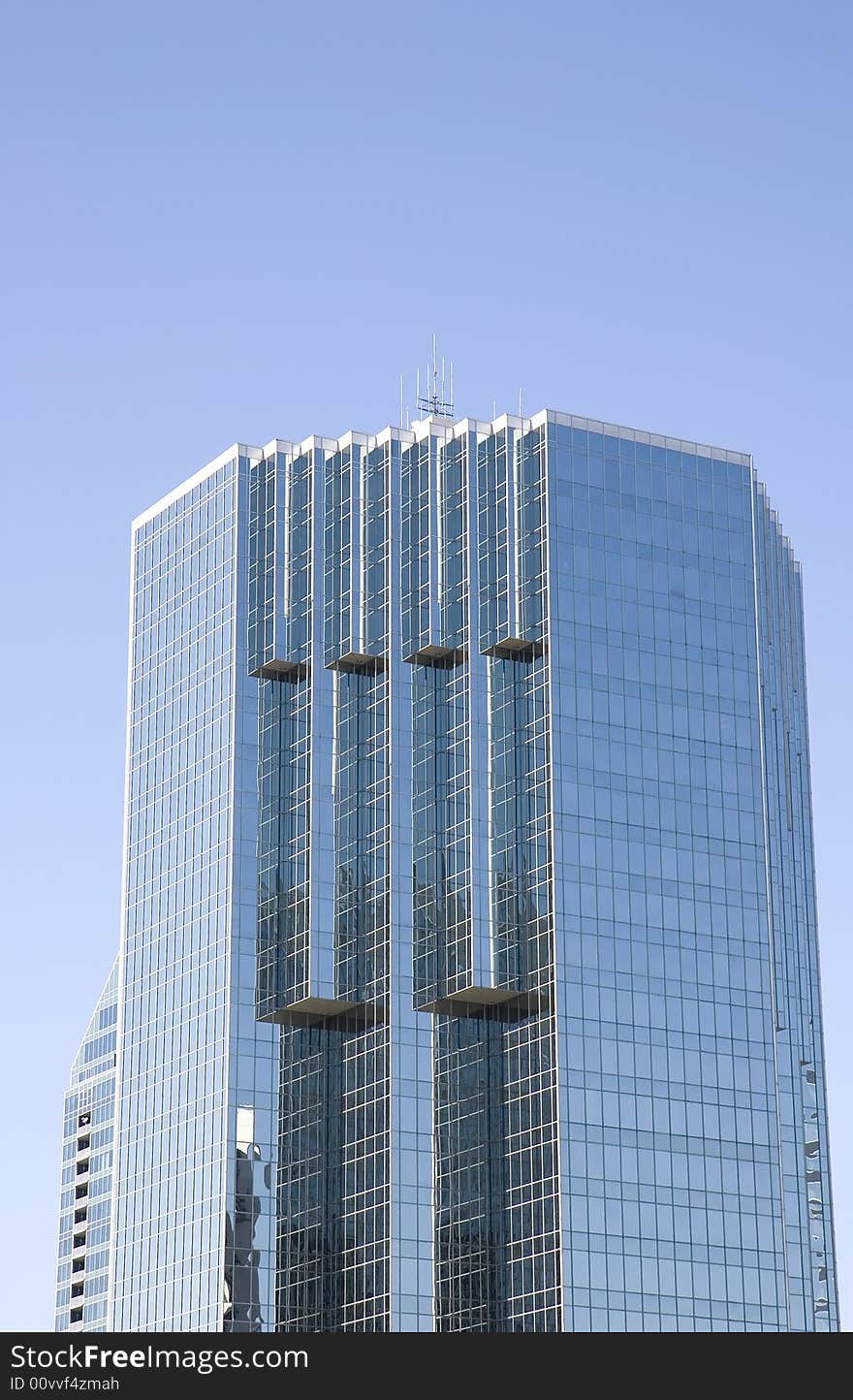 A modern blue glass office building with many angles. A modern blue glass office building with many angles