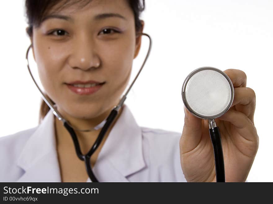 Female doctor holding a stethoscope in white background. Female doctor holding a stethoscope in white background.