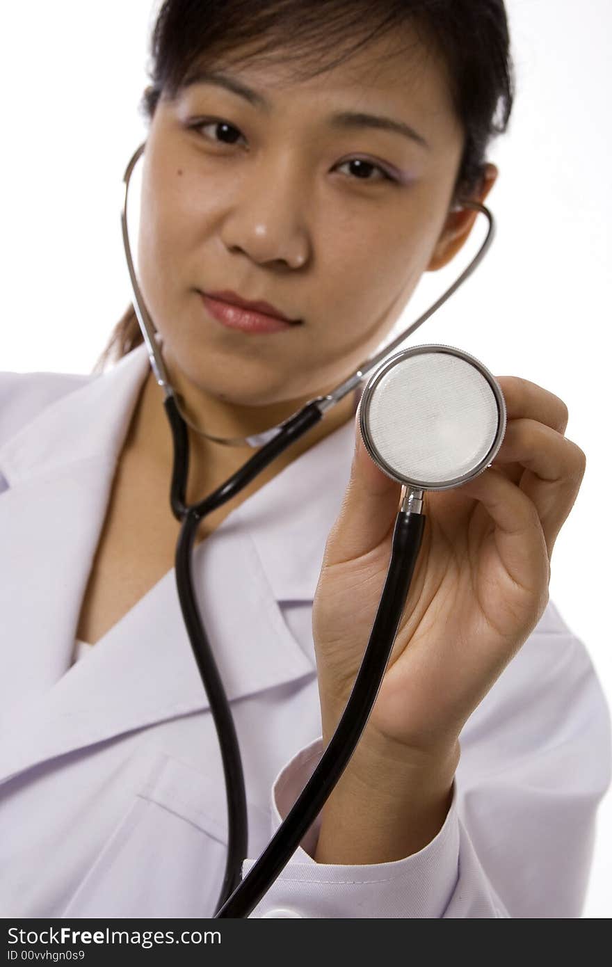 Female doctor holding a stethoscope in white background. Female doctor holding a stethoscope in white background.