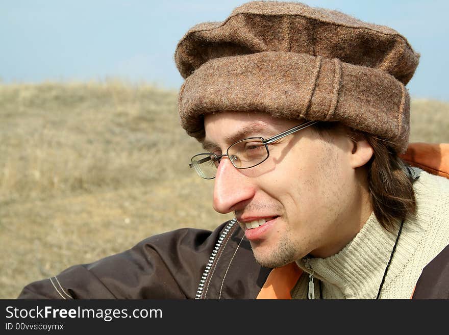 Portrait of man in hat on background of nature. Portrait of man in hat on background of nature