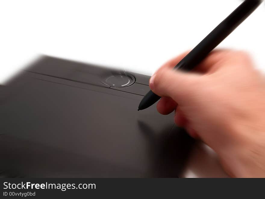 A human hand holding pen on graphic tablet for computer. A human hand holding pen on graphic tablet for computer.