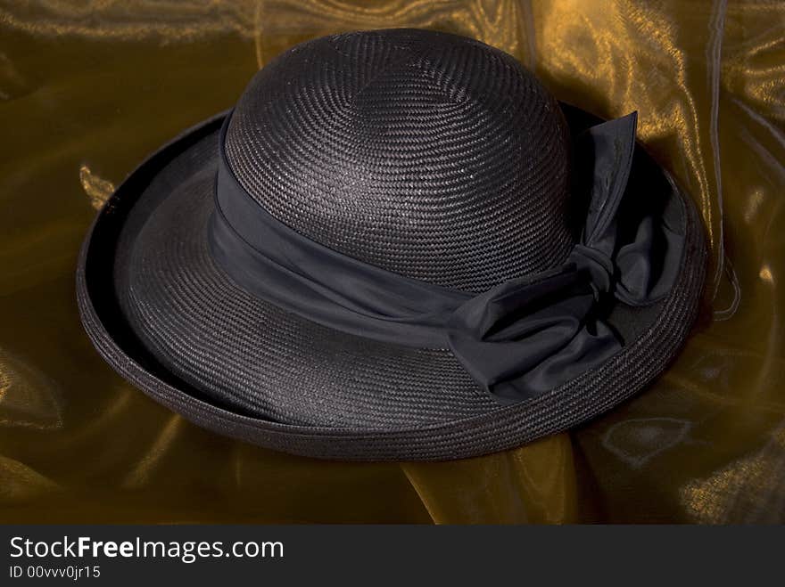 Dark blue ladies hat on gold background