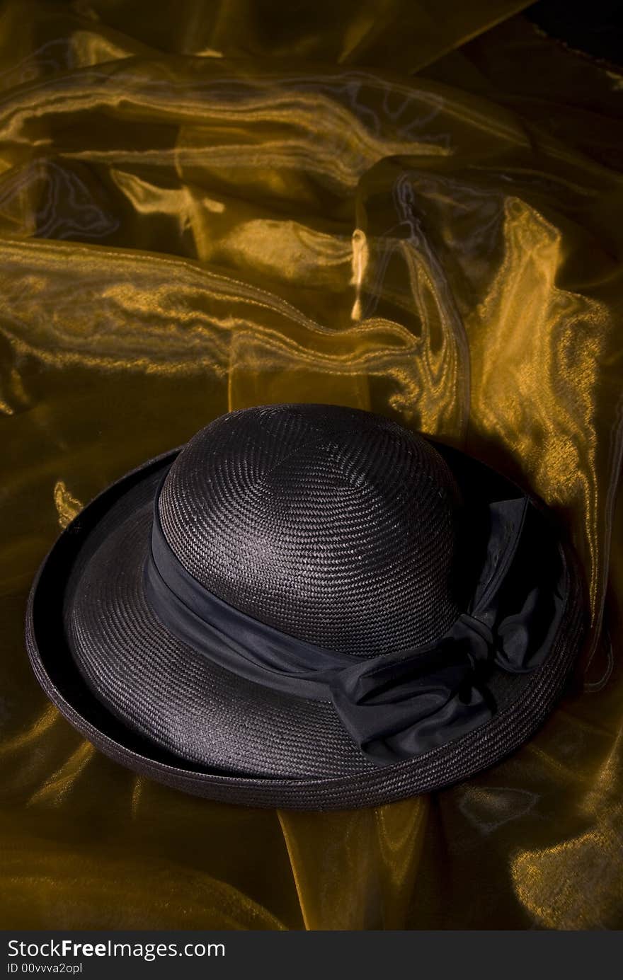 Dark blue ladies hat on gold background