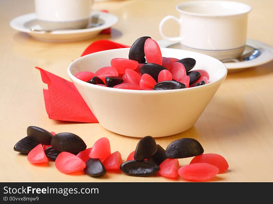 Candy with coffee cups in the background. Candy with coffee cups in the background