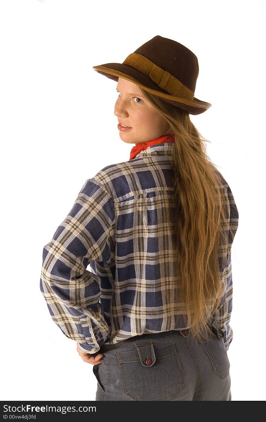 Young woman in cowboy dress looking backward