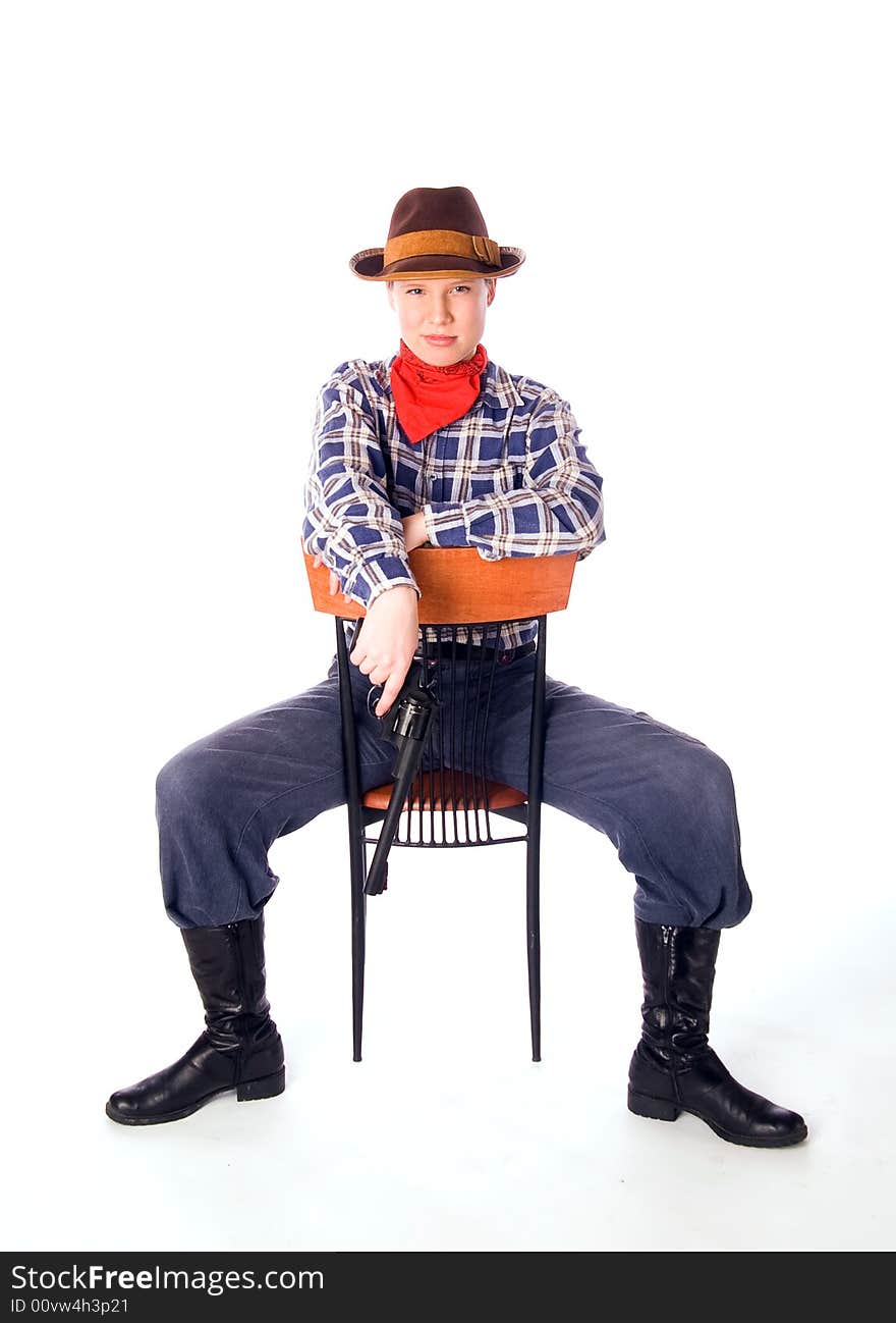 Cowgirl with gun siiting on chair and glares down upon all with the utmost contempt (isolated on white)