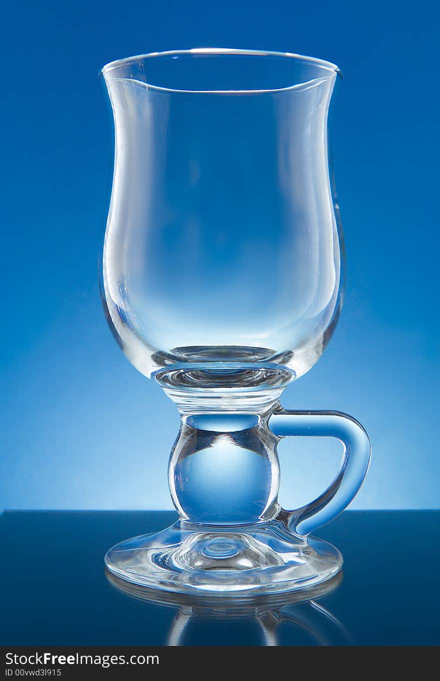 Irish coffee glass back lit over blue background