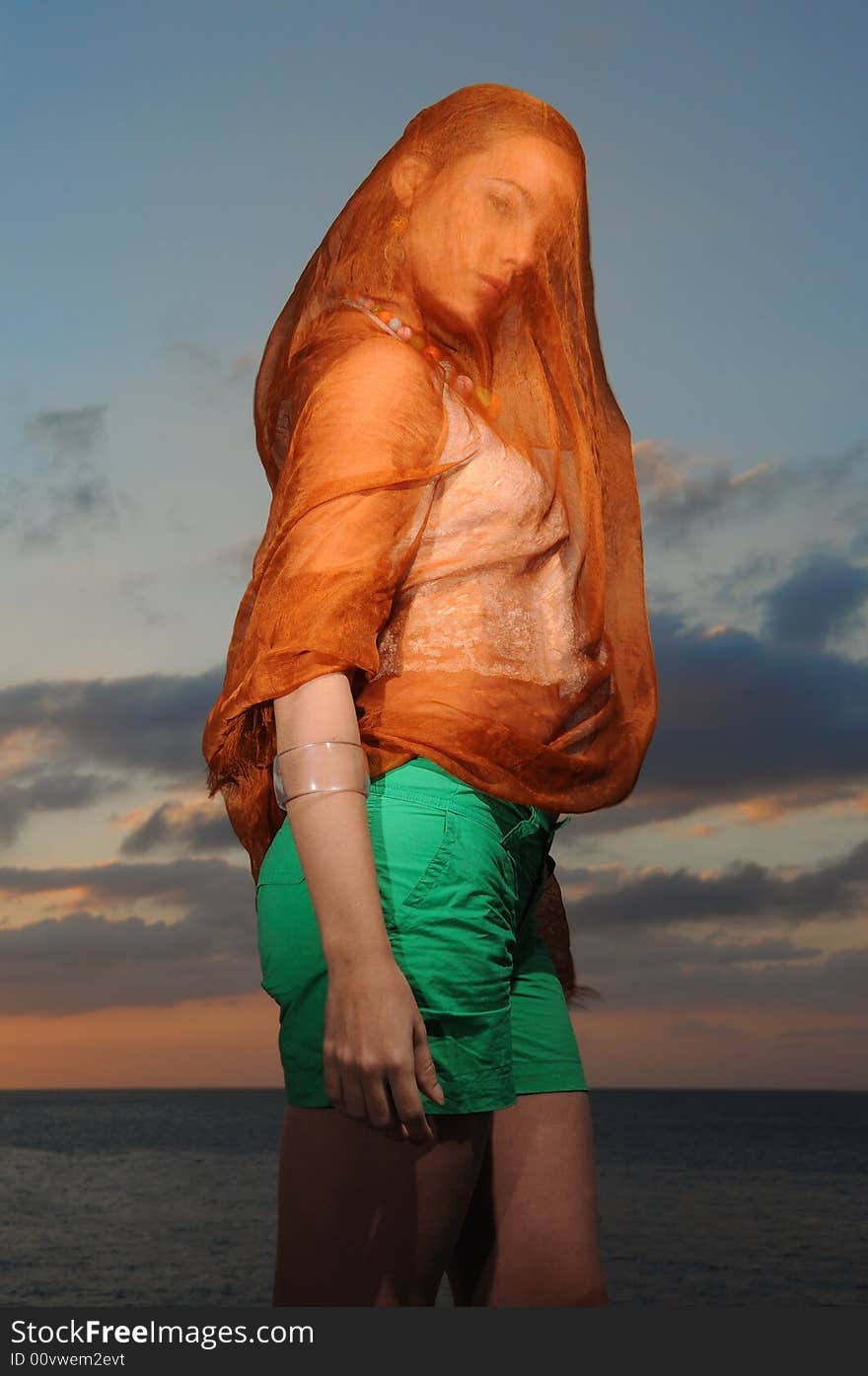 Portrait of seductive woman covered by orange veil. Portrait of seductive woman covered by orange veil