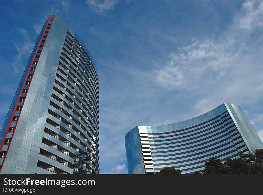 The reflection of the sky and clouds on a curved building. The reflection of the sky and clouds on a curved building.