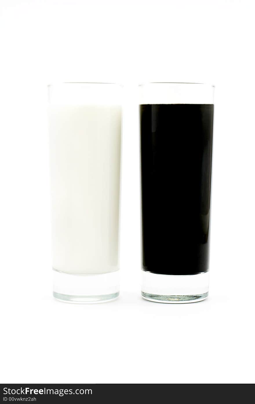 Isolated photo of glasses of black and white liquids