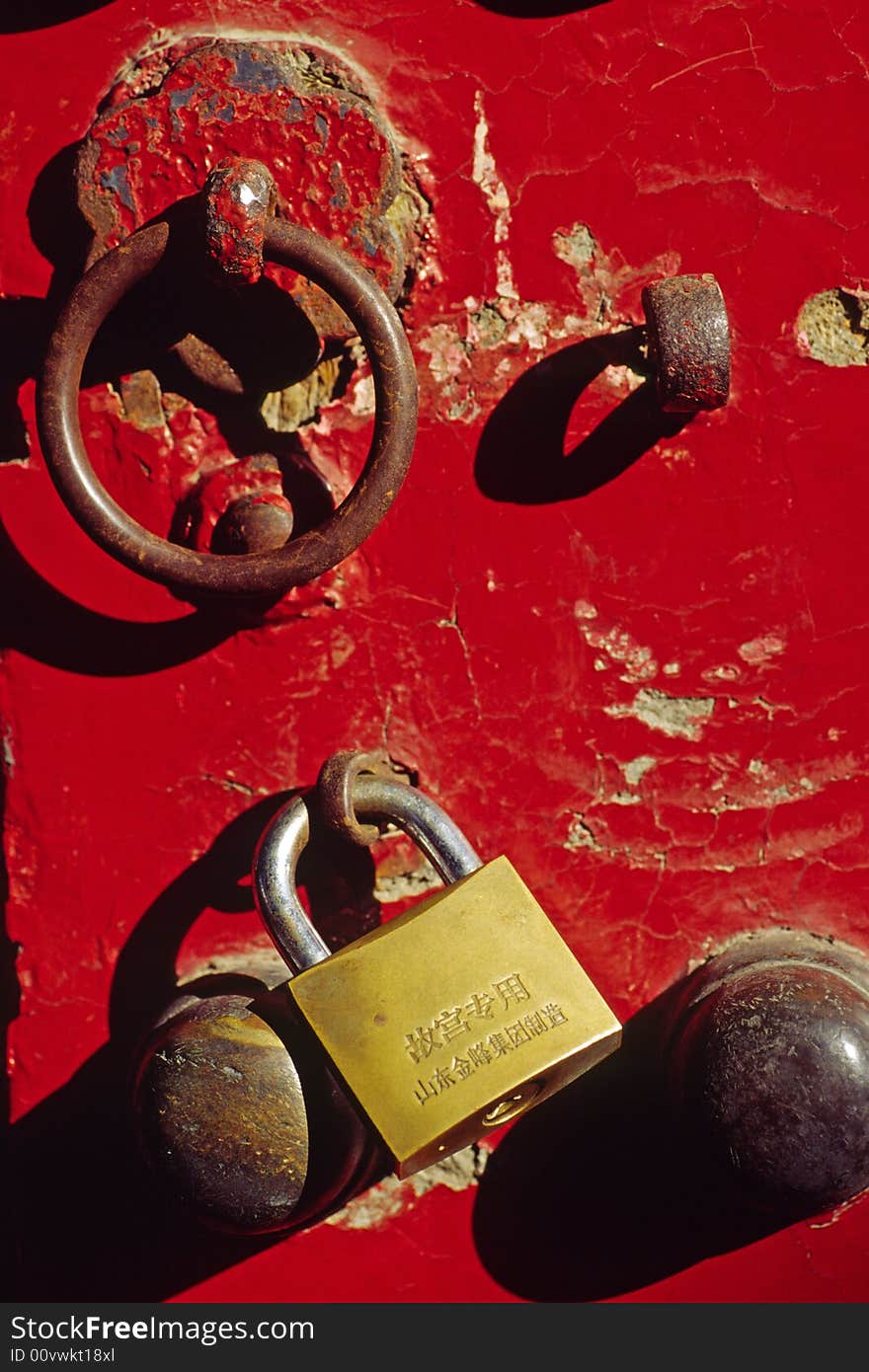 Traditional knocker and new lock on a red door, the forbidden city, china. Traditional knocker and new lock on a red door, the forbidden city, china