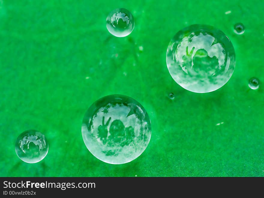 Reflections of photographer doing a peace sign reflecting on water droplets on lotus leaf. Reflections of photographer doing a peace sign reflecting on water droplets on lotus leaf.