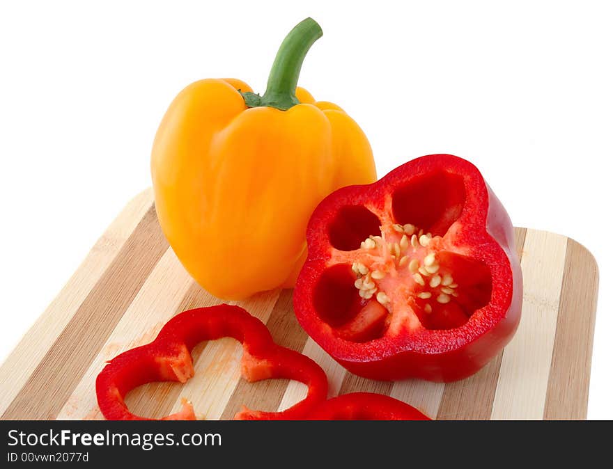 Red and yellow paprika on bamboo cutting board. Red and yellow paprika on bamboo cutting board