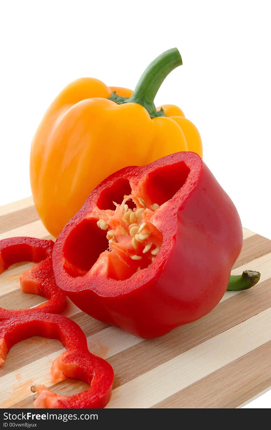 Red and yellow paprika on bamboo cutting board. Red and yellow paprika on bamboo cutting board