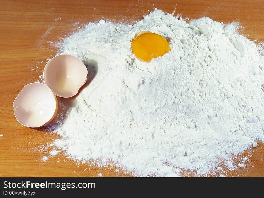 Flour, egg and shell on a table in kitchen