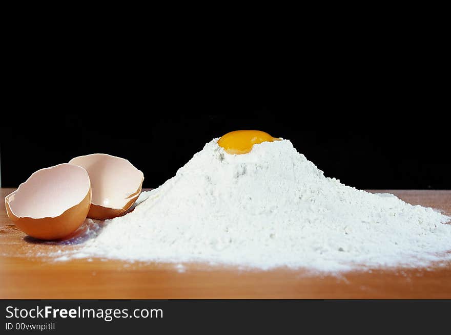 Flour, egg and shell on a table in kitchen