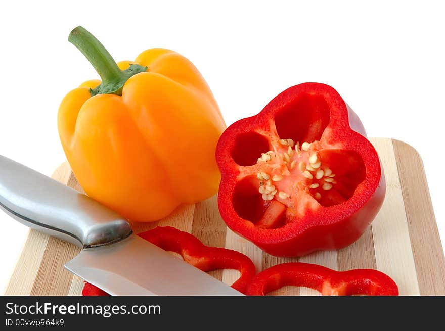 Red and yellow paprika on bamboo cutting board. Red and yellow paprika on bamboo cutting board