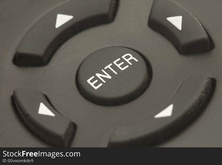 Black remote control, ENTER button in the middle, direction buttons on sides. Black remote control, ENTER button in the middle, direction buttons on sides