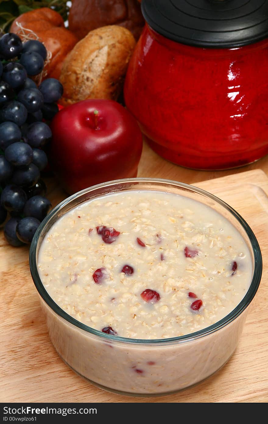 Oatmean and craisins (dried cranberries) in glass bowl in kitchen or restaurant. Oatmean and craisins (dried cranberries) in glass bowl in kitchen or restaurant.