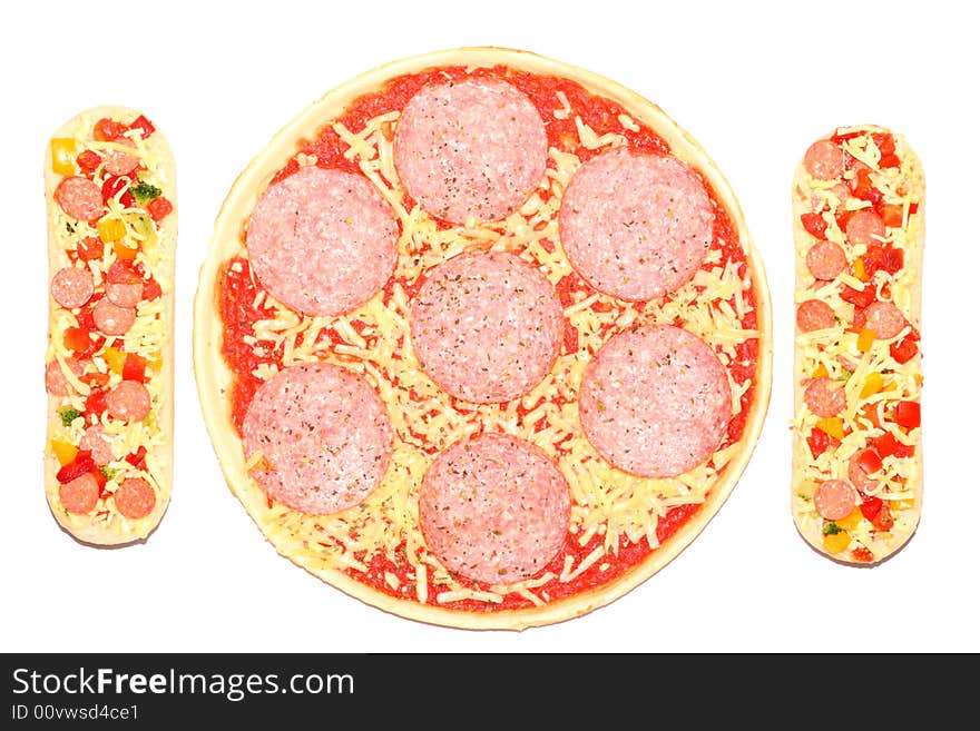 Uncooked, frozen pizza and baguettes isolated on a white background. Uncooked, frozen pizza and baguettes isolated on a white background.