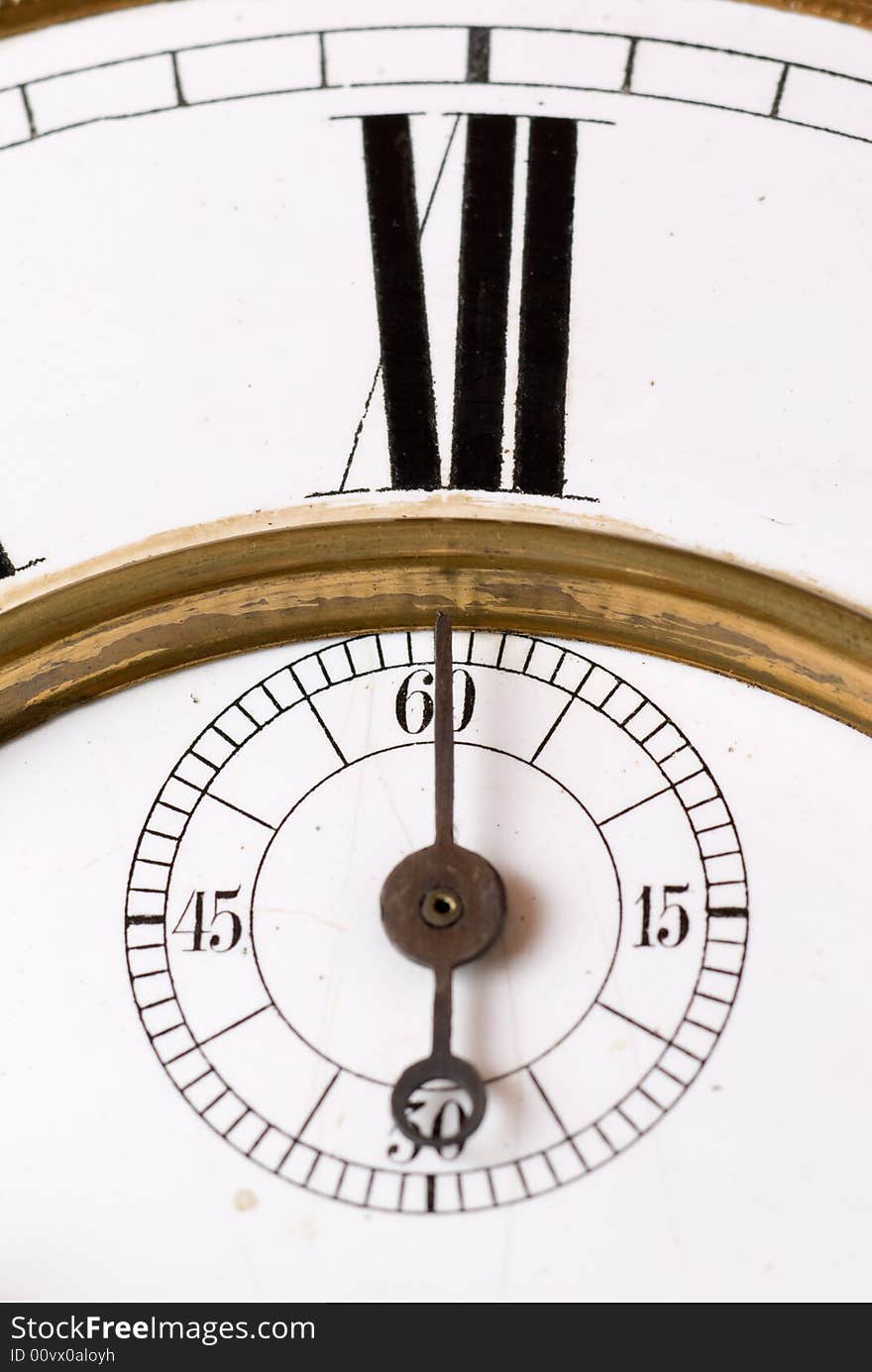 Old clock face detail with roman numerals - focus on the second hand. Old clock face detail with roman numerals - focus on the second hand.