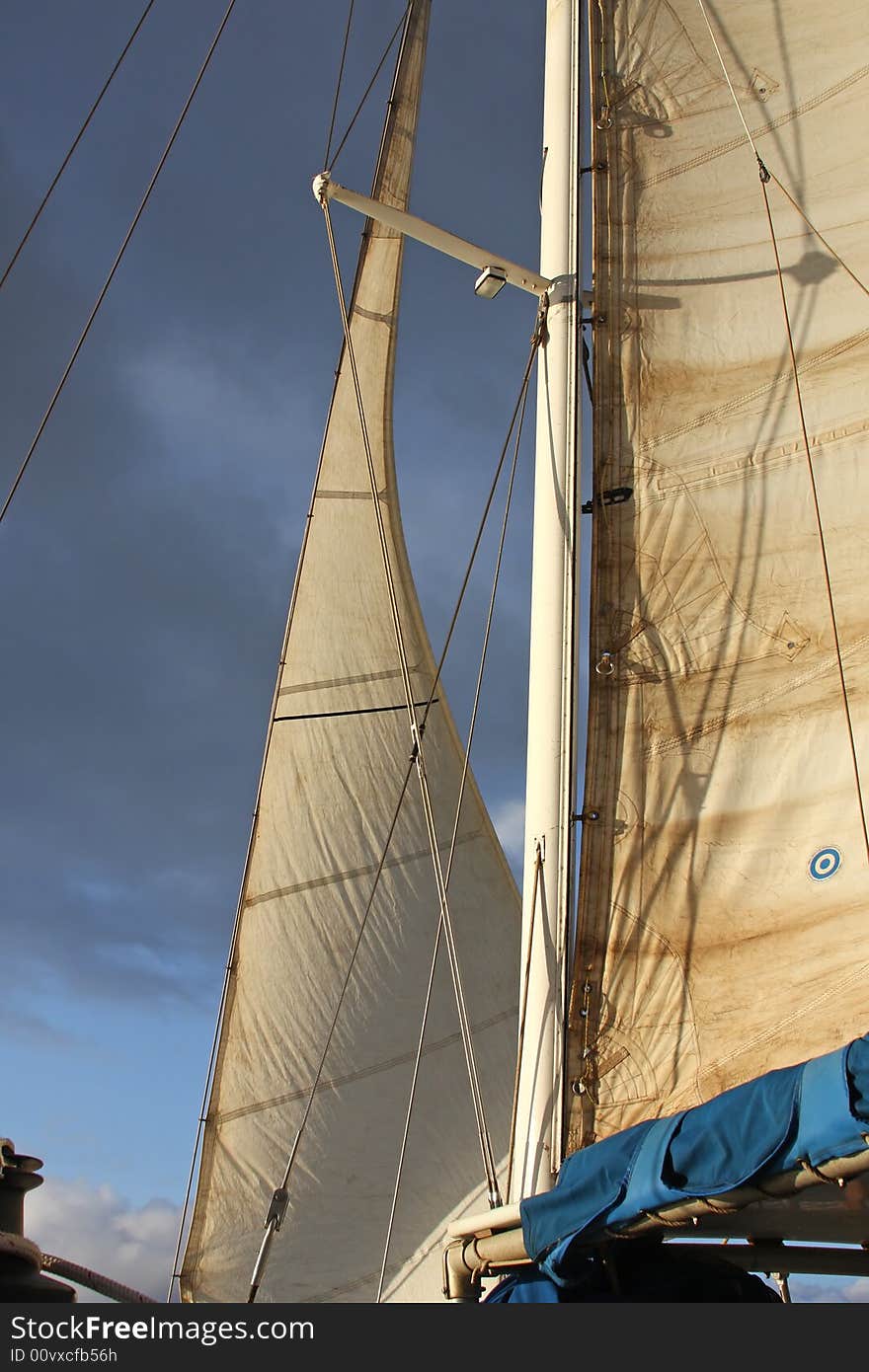 Partial sails shown below a stormy looking sky. Partial sails shown below a stormy looking sky.