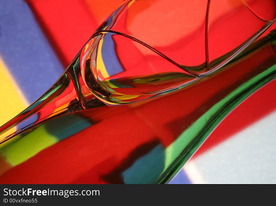 Abstract background design made from numerous colors and a bottle and glass.