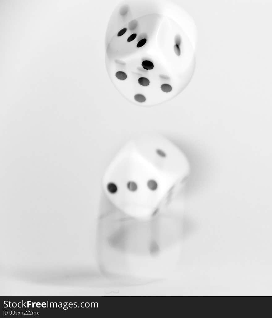 Dice been thrown on a white  background with a slow shutter speed to catch the movement trails. Dice been thrown on a white  background with a slow shutter speed to catch the movement trails