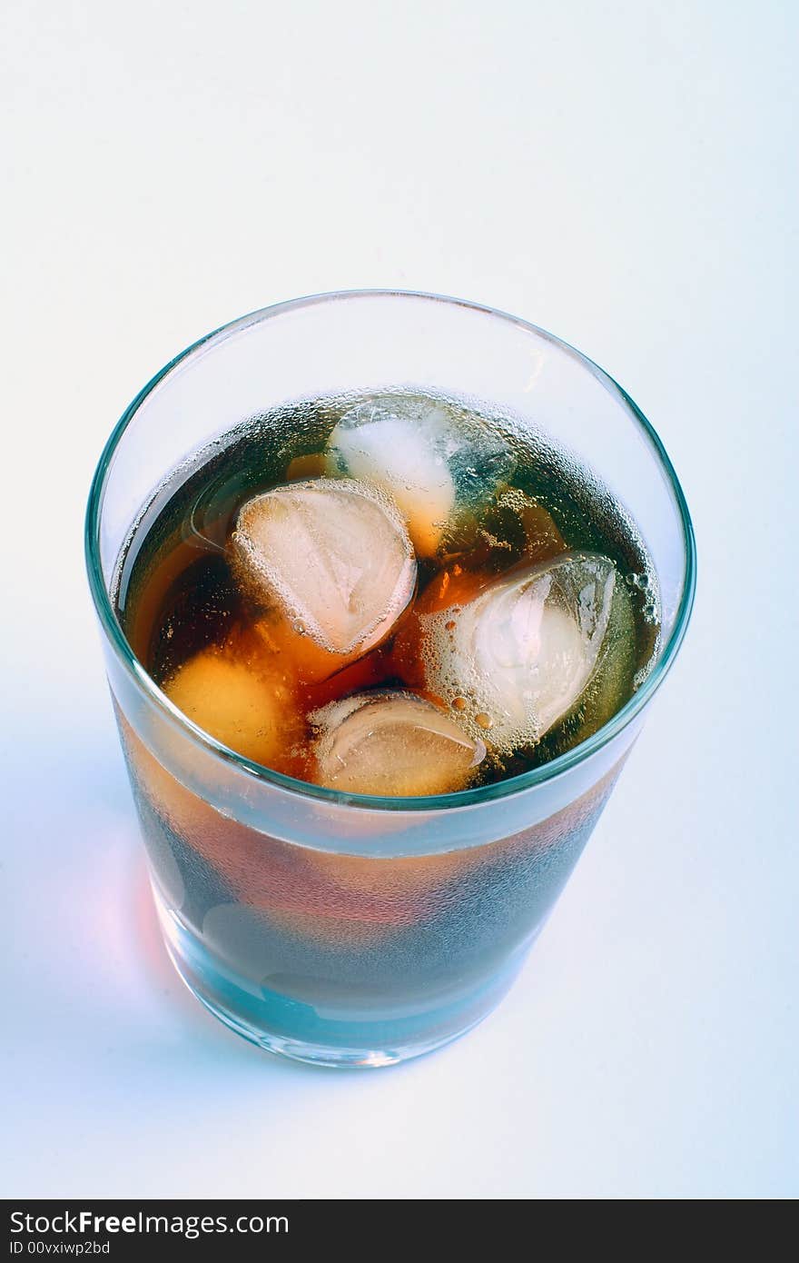 Wine-glass with a red drink and an ice