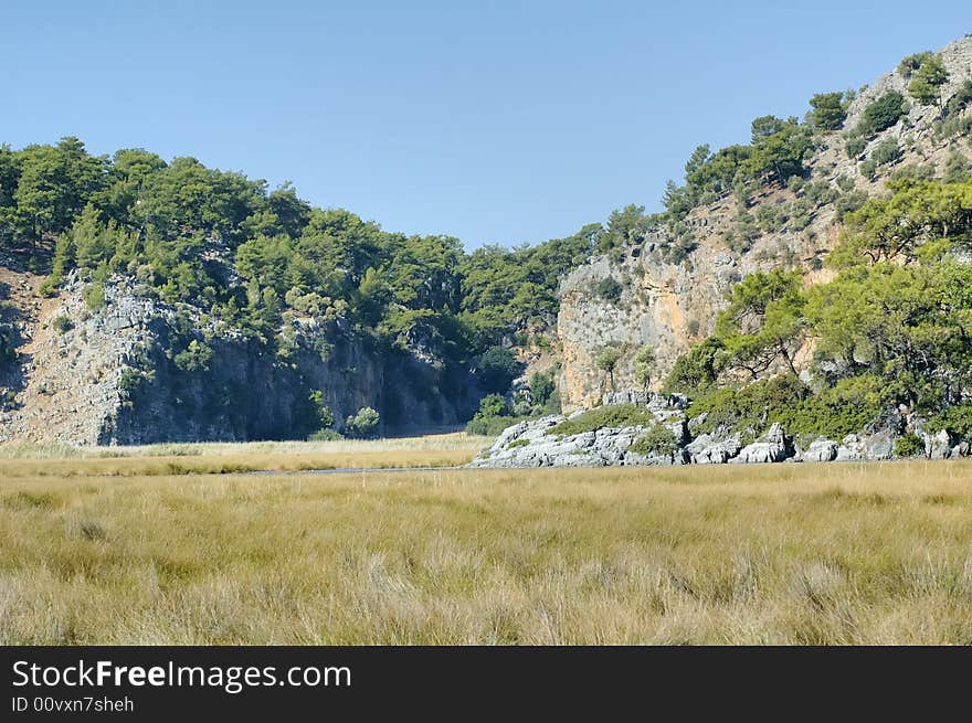 View on crevice between mountains with rush on foreground