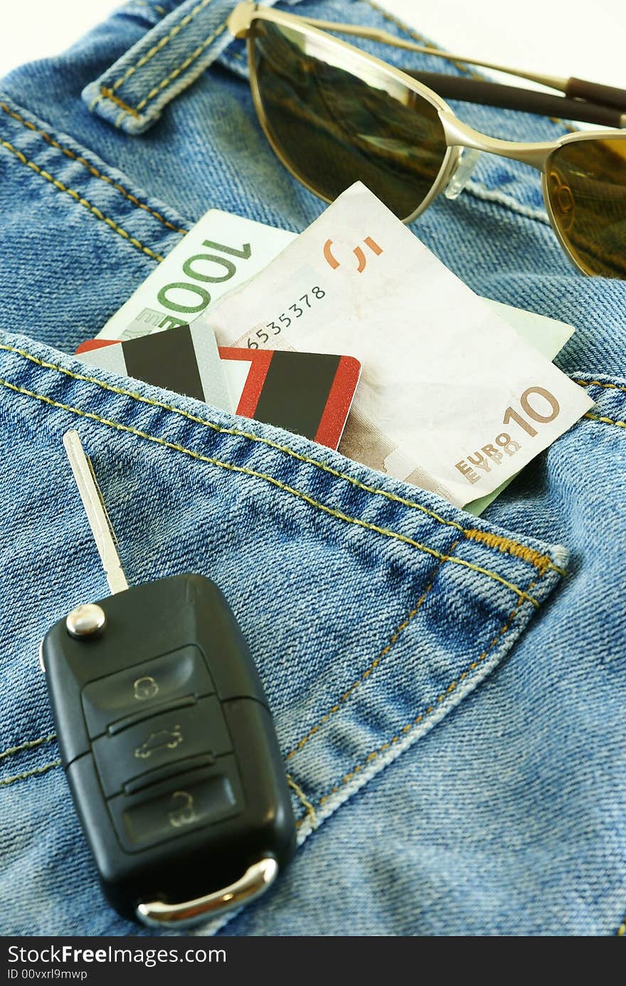 Conceptual shot Ready to travel with jeans, money, credit cards and car key