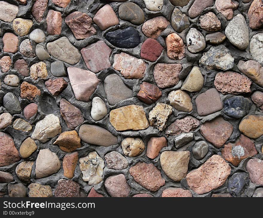 Small stones in a wall background. Small stones in a wall background