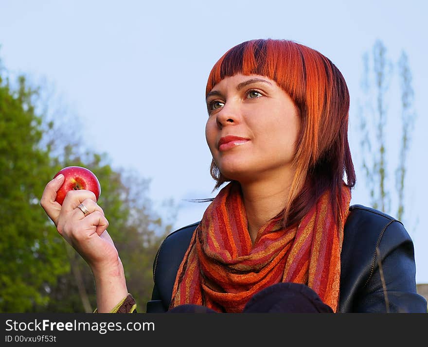 The beautiful young girl and red apple