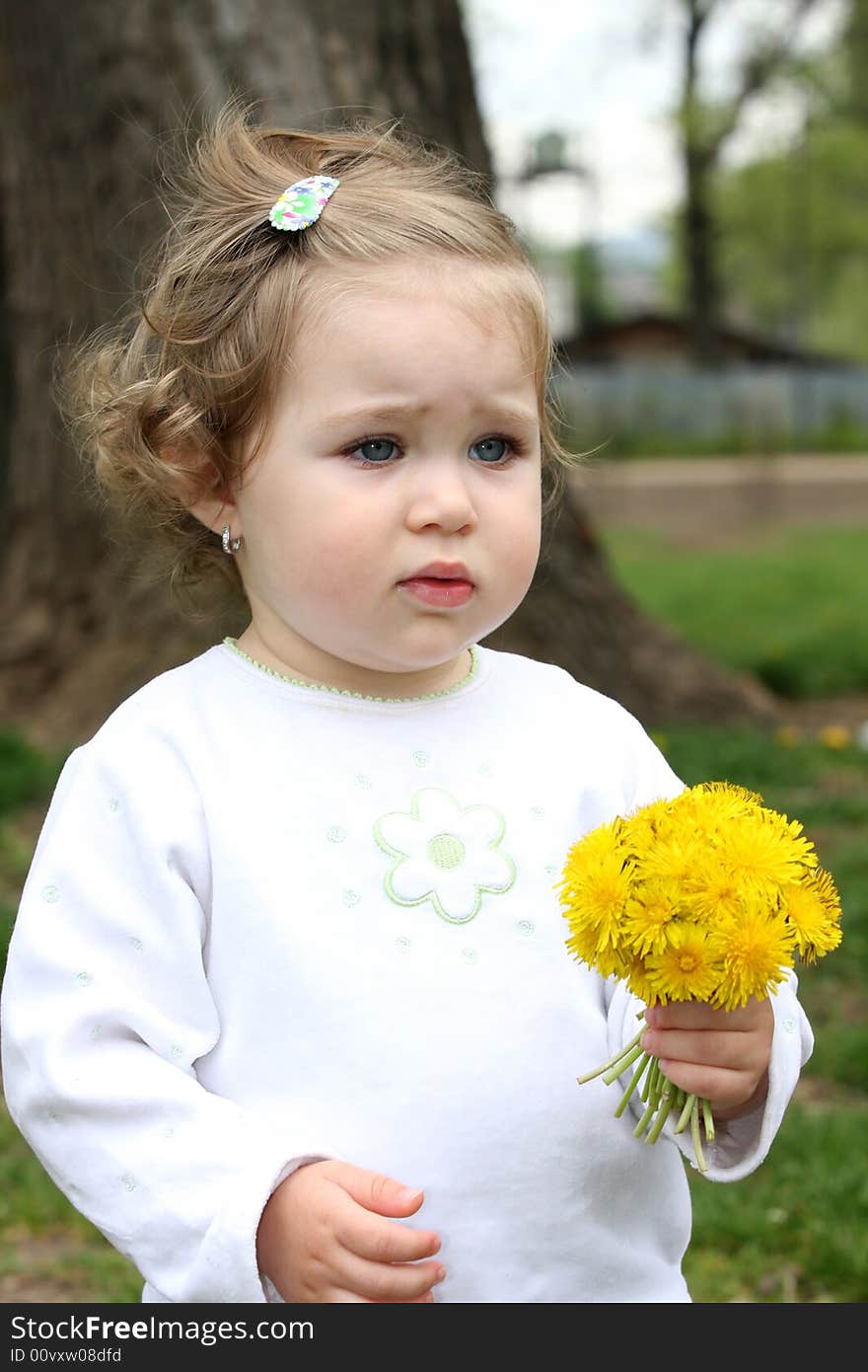 Beautiful pretty girl with flower in the park