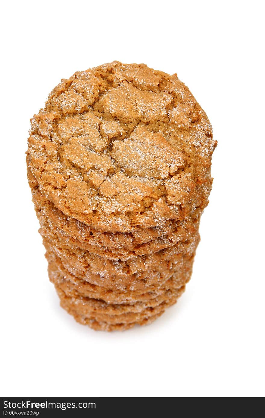 Stack of chewy ginger cookies over white.