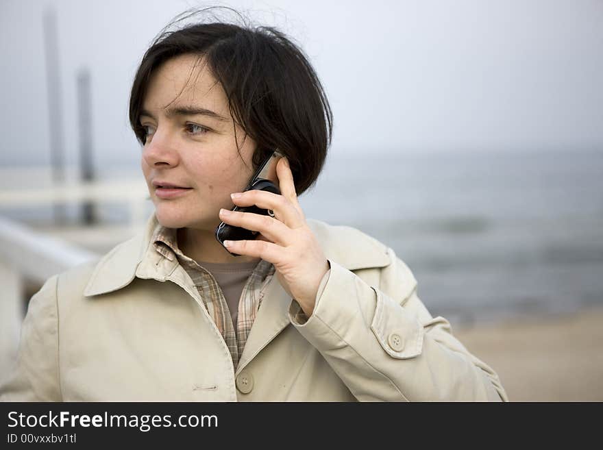 Businesswoman having a phone conversation and smiling.