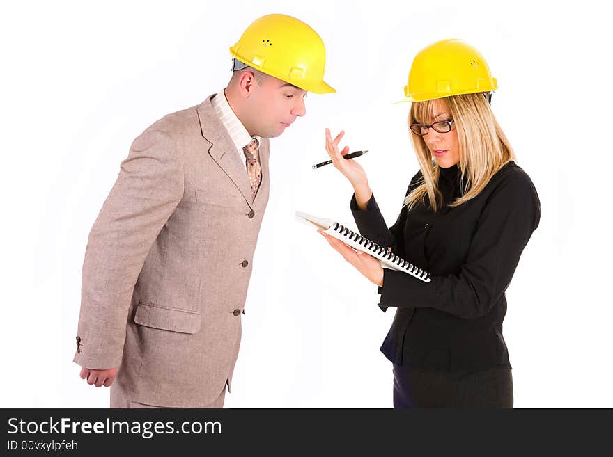 Angry businesswoman and architect looking at architectural plans