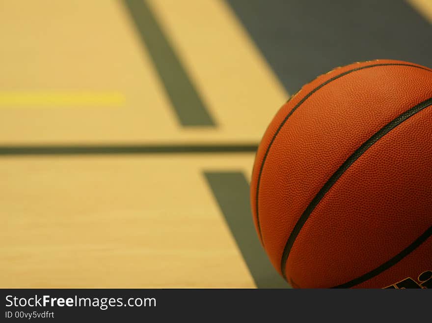 Close up of basketball on gym floor. Close up of basketball on gym floor