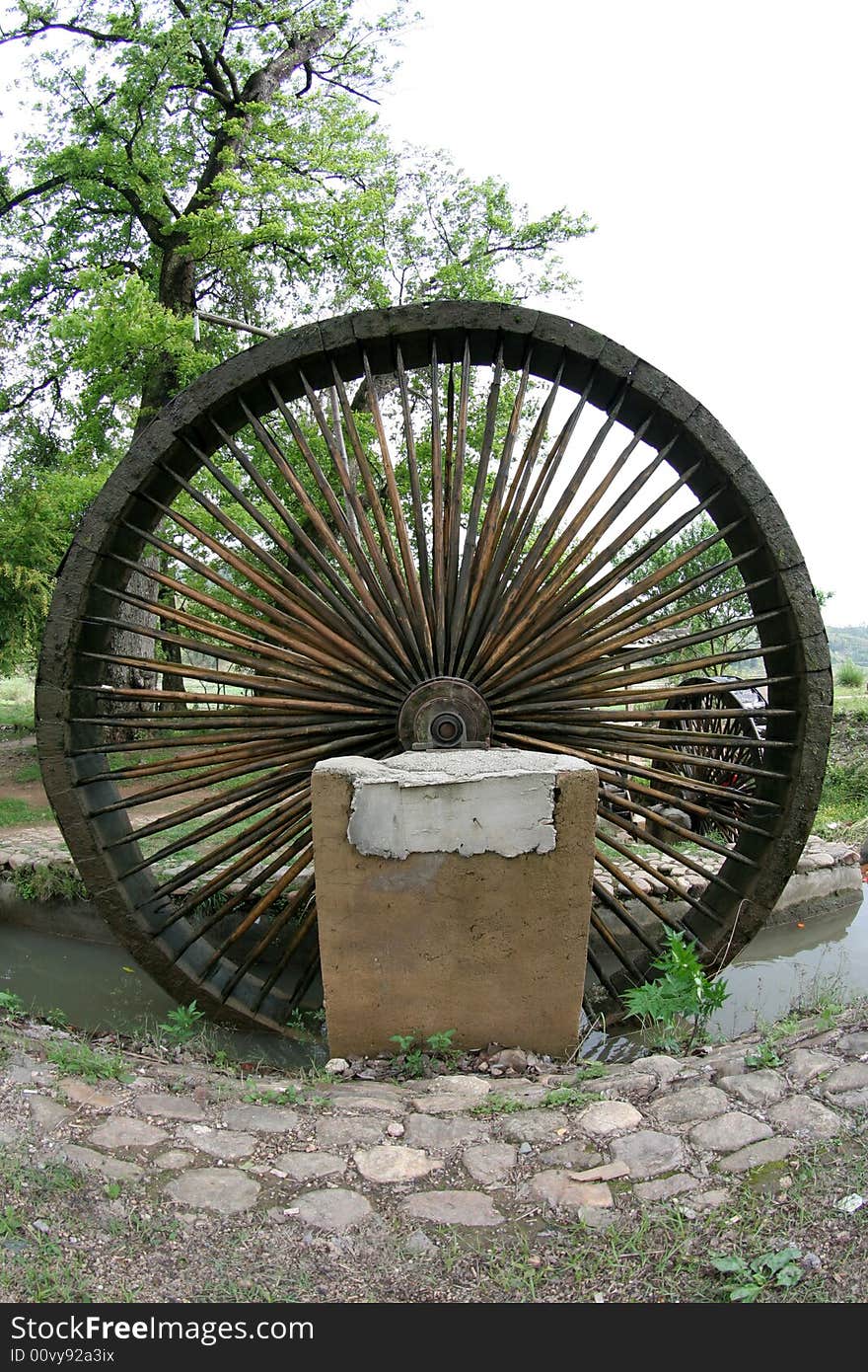 A large water wood mill wheel. A large water wood mill wheel