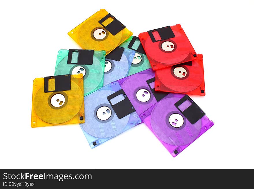 Several floppy disks of different colors scattered over a white surface. Several floppy disks of different colors scattered over a white surface