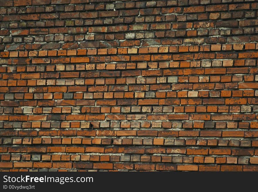 Brick wall made from yellow and grey bricks